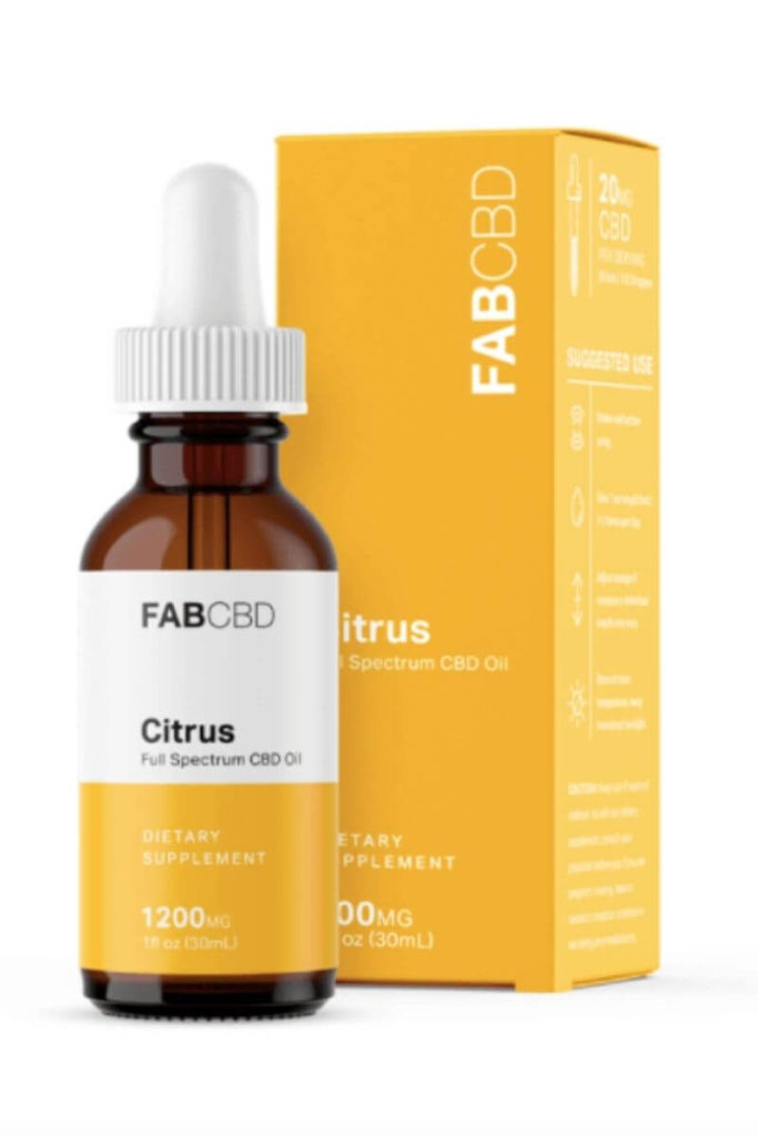 Bottle of FAB CBD Citrus CBD oil standing to the left of its box.