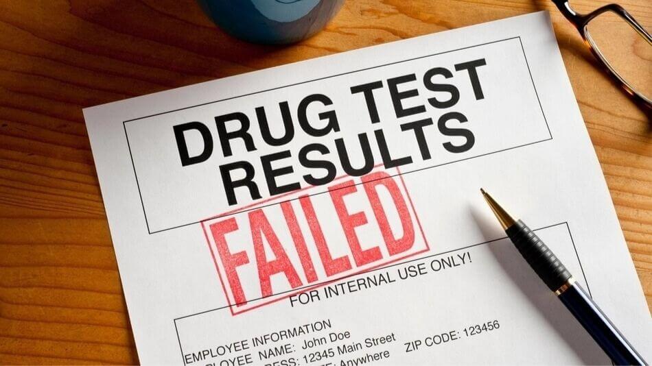 A paper sitting on a desk that says DRUG TEST RESULTS FAILED.