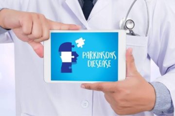 Doctor wearing white residency jacket holding an iPad with a picture of an animated head and the words Parkinson's disease.