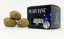 Three Plain Jane moon rocks sitting next to the 8th jar and box.