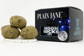 Three Plain Jane moon rocks sitting next to the 8th jar and box.