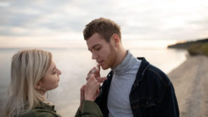 Couple smoking a joint on the beach.