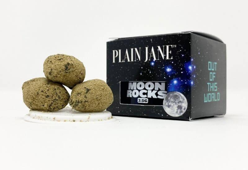 Three Plain Jane moon rocks sitting next to the 8th jar and box.