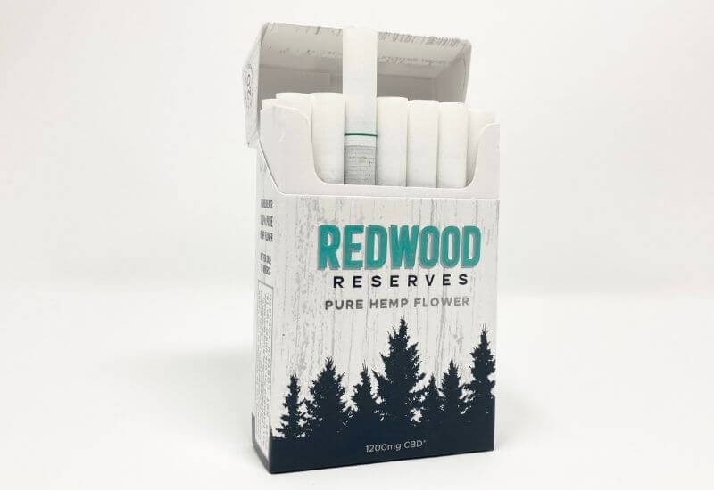 Redwood Reserve menthol CBD hemp flower cigarette box with the top open and a single cigarette sticking out of the top.