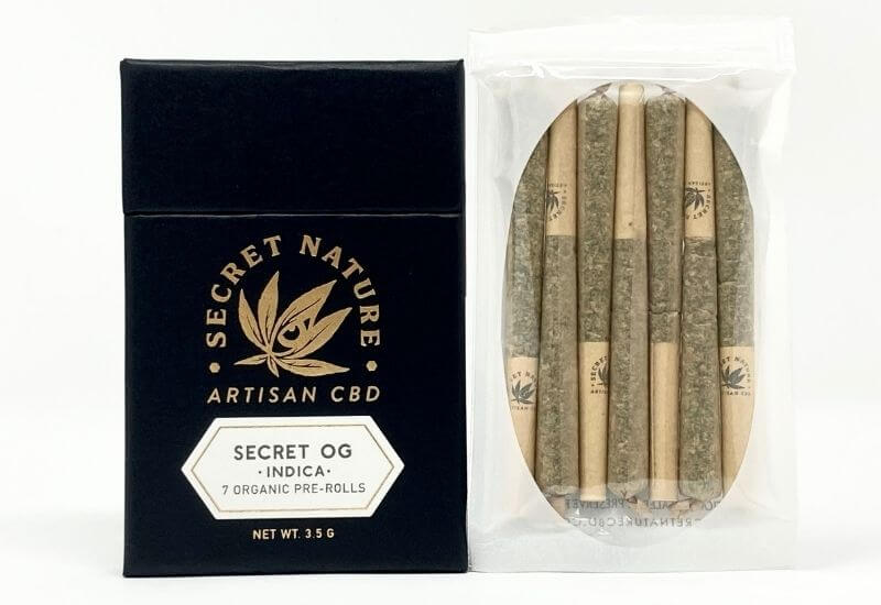 Pack of seven Secret Nature Secret OG prerolls with the hermetically sealed bag filled with prerolls to the right.